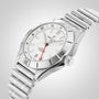 The Breitling Chronomat Automatic GMT 40 features a stainless steel case, white dial, date display, red GMT hand for dual time zones, and a metal link bracelet, set against a light gradient background.