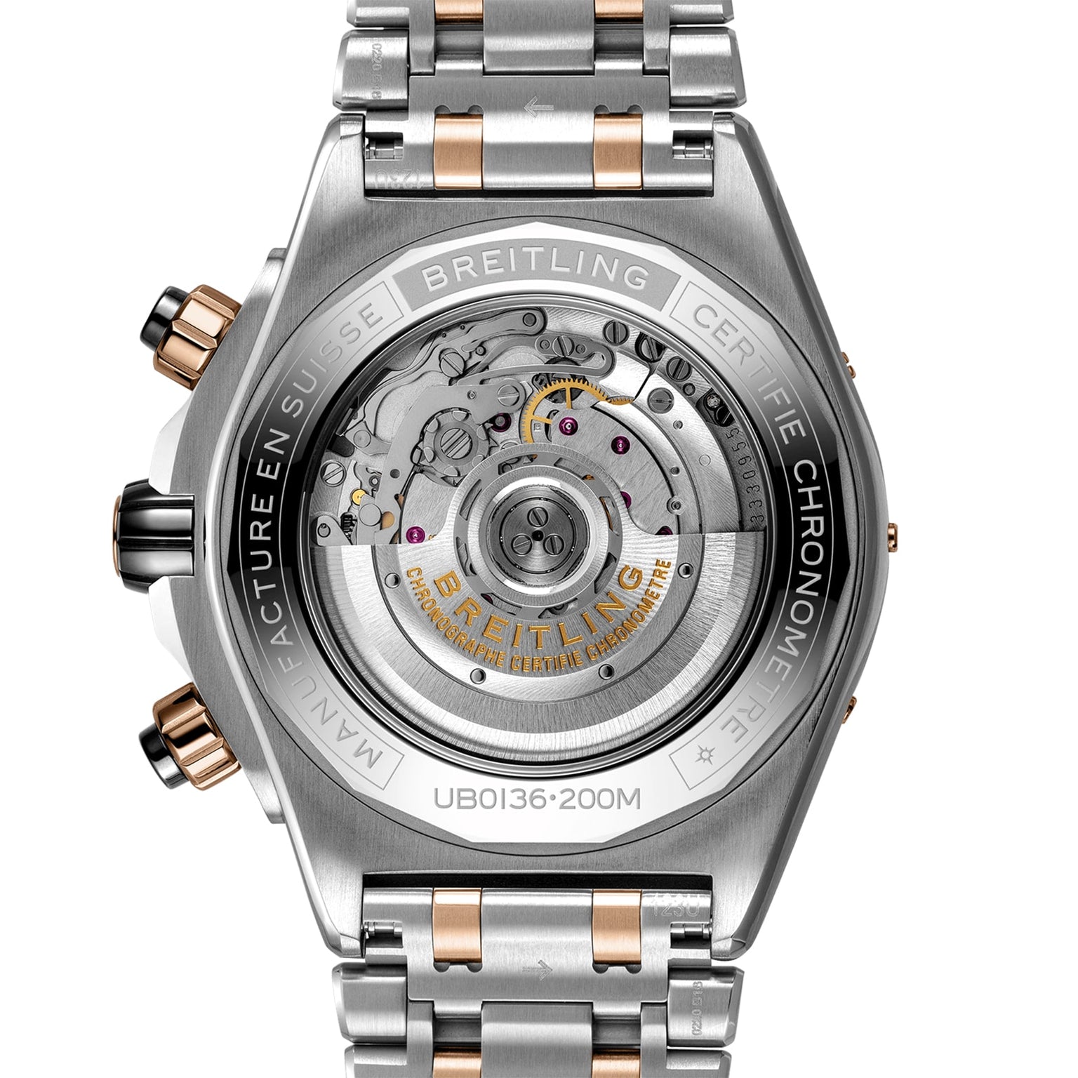 Close-up view of the Super Chronomat B01 44 case back by Breitling, featuring the exposed Breitling Manufacture 01 Movement and engraved brand markings on a two-tone metal bracelet.