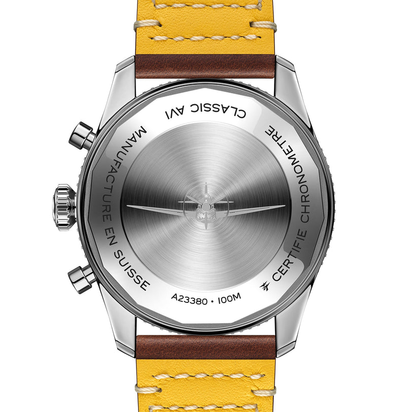 The back view of a Breitling Classic AVI Chronograph 42 Curtiss Warhawk, stainless steel, with a yellow and brown leather strap, engraved MANUFACTURE EN SUISSE, CERTIFIE CHRONOMETRE, and featuring the renowned Breitling 23 calibre.