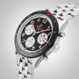 The Breitling Classic AVI Chronograph 42 Mosquito features a stainless steel case, black bezel, black and white dial with three subdials, red hands, and metal bracelet—a striking tribute to aviation history.