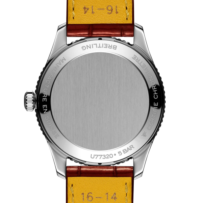 Close-up of the back of a Breitling Navitimer 32 wristwatch, featuring a silver case, brown leather strap, and engraved model details.