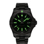 A Breitling Avenger Automatic 42 wristwatch with a black case, military green dial, luminous green markers and hands, date at 3 o’clock, and metal bracelet is displayed against a white background.