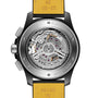 Close-up of the Avenger B01 Chronograph 44 Night Mission Bloodhounds by Breitling, showing the exposed Manufacture Caliber 01 movement, engraved details, and a black and yellow leather strap inspired by jet pilots.