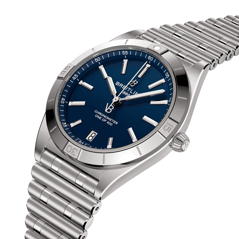 The Breitling Chronomat Automatic 36 Victoria Beckham features a blue dial, silver markers and hands, a date window at 6 o’clock, and a stainless steel link bracelet.