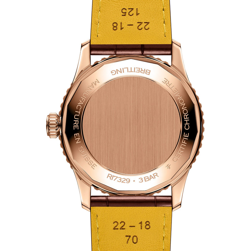 Back view of the Breitling Navitimer Automatic 41, featuring an 18K red gold case and yellow leather strap, with engraved certifications on the case back—a true icon among mechanical chronographs.