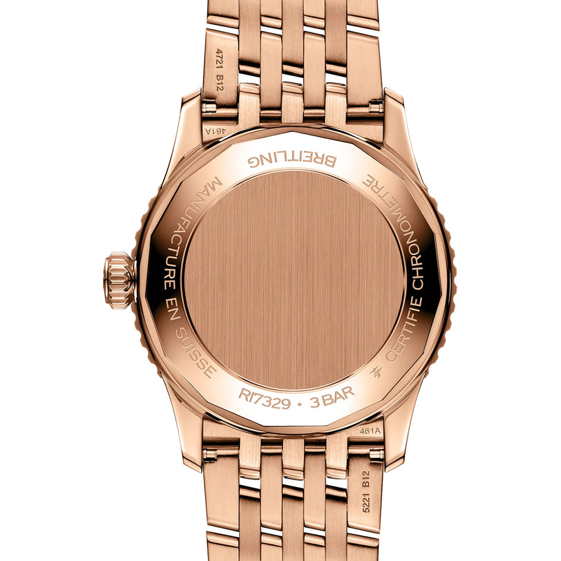 Close-up of the back of a Breitling Navitimer Automatic 41 wristwatch with a rose gold metal band, engraved text, and a blank round case back.