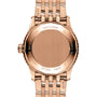 Close-up of the back of a Breitling Navitimer Automatic 41 wristwatch with a rose gold metal band, engraved text, and a blank round case back.