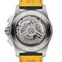 Close-up of the back of the Breitling Avenger B01 Chronograph 42, featuring its visible automatic movement and engraved titanium case back, finished with a bold yellow strap.