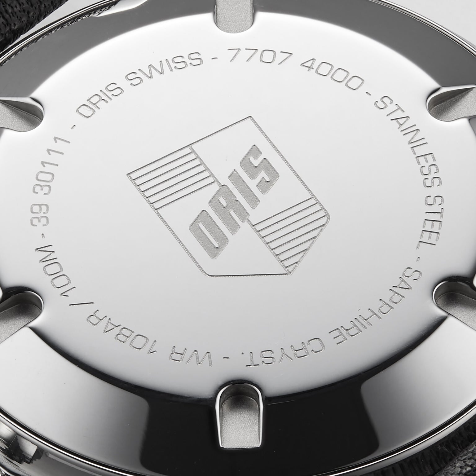 Close-up of the Oris Divers Sixty‑Five Swiss watchs stainless steel case back, featuring engraved details and the Oris logo.