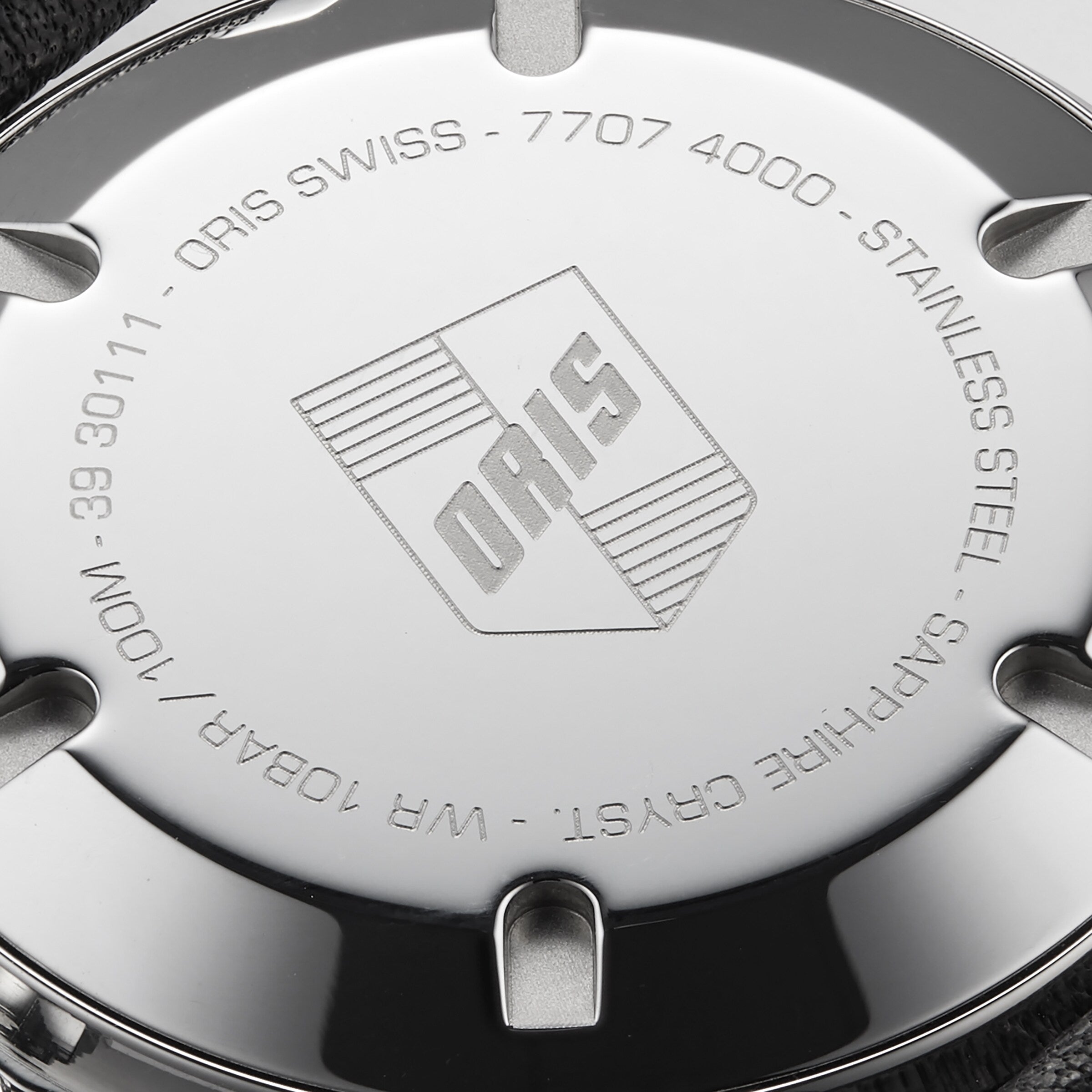 Close-up of the Oris Divers Sixty‑Five Swiss watchs stainless steel case back, featuring engraved details and the Oris logo.