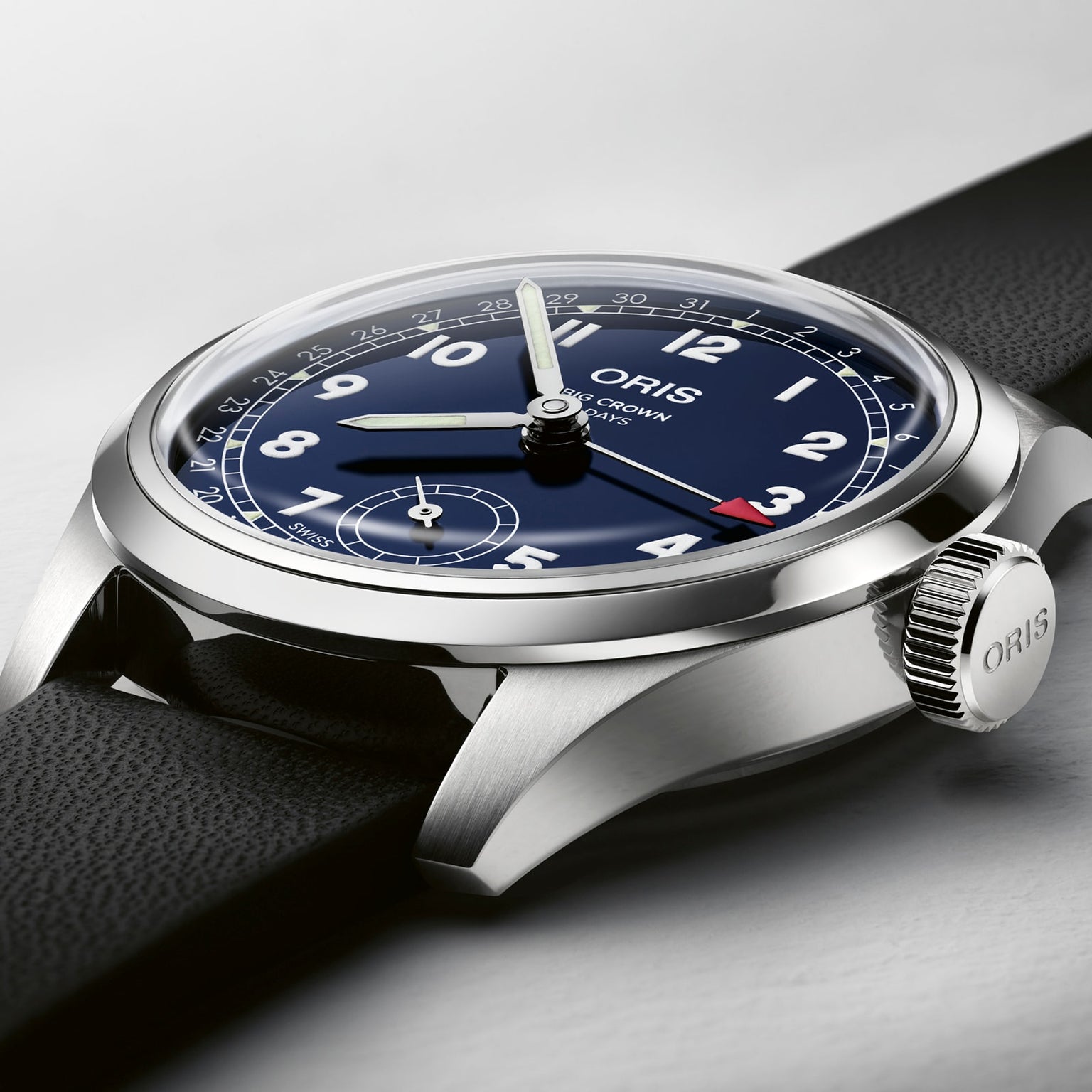 Close-up of the Oris Big Crown Pointer Date Calibre 403 wristwatch with a black leather strap, blue dial, white numerals, and silver casing, displaying the time at 10:10.