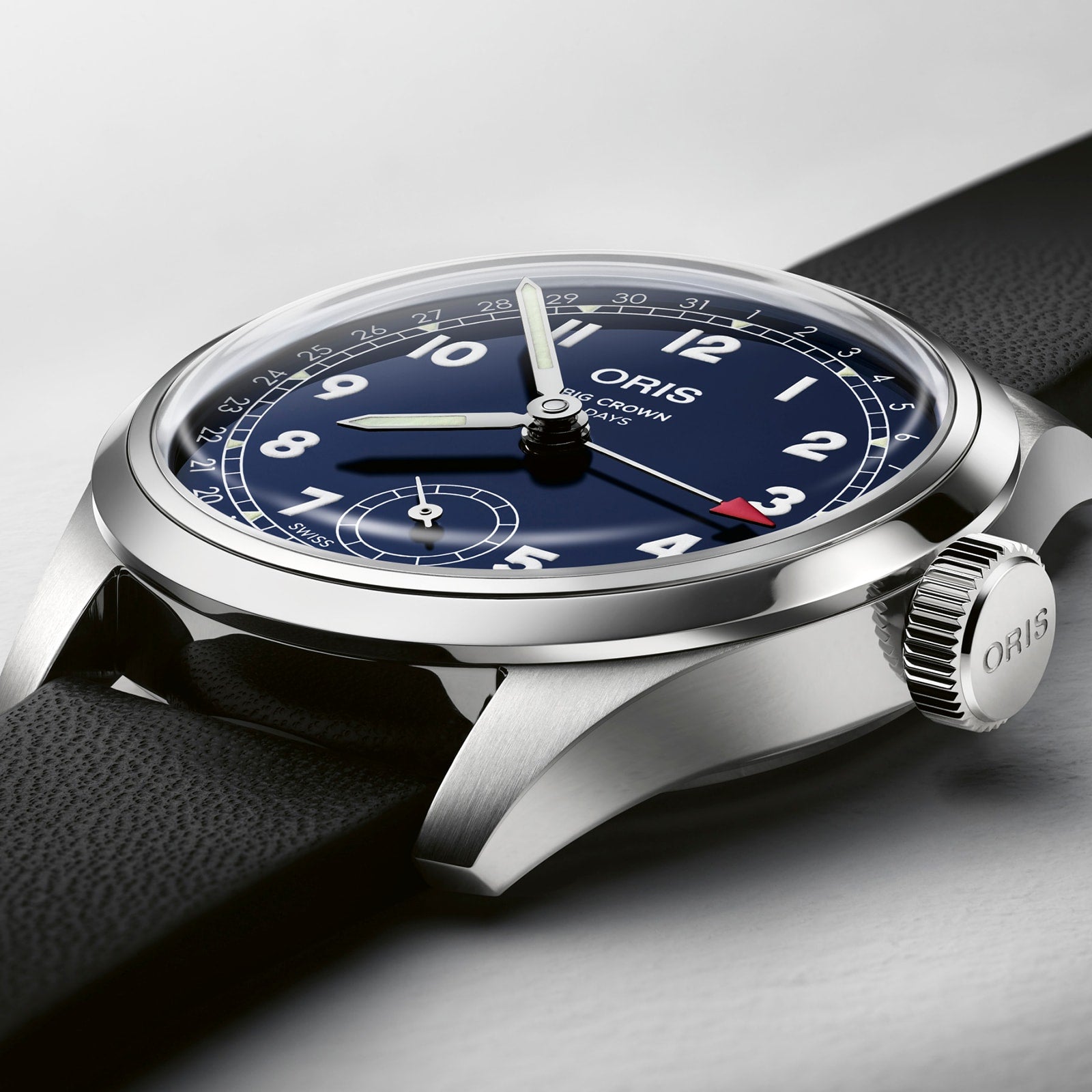 Close-up of the Oris Big Crown Pointer Date Calibre 403 wristwatch with a black leather strap, blue dial, white numerals, and silver casing, displaying the time at 10:10.