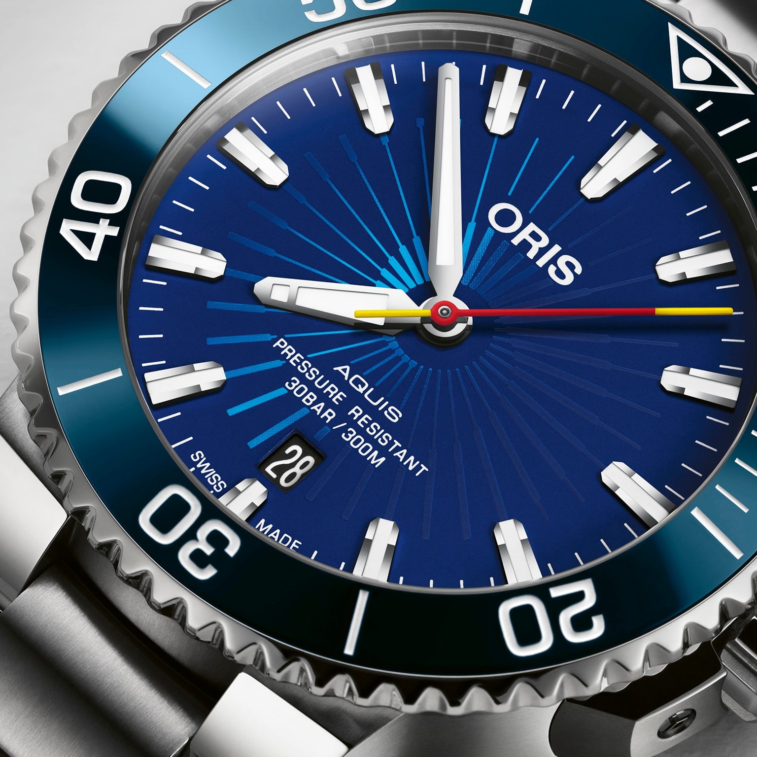 Close-up of the Oris Aquis Sun Wukong Limited Edition watch, featuring a blue dial, white markers, date window at 6 oclock, and stainless steel bezel and bracelet.