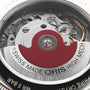 Close-up of a mechanical watch movement with visible gears and a red rotor engraved with Swiss Made Oris High Mech, reflecting the precision in every Oris Big Crown Oris X Cervo Volante timepiece.