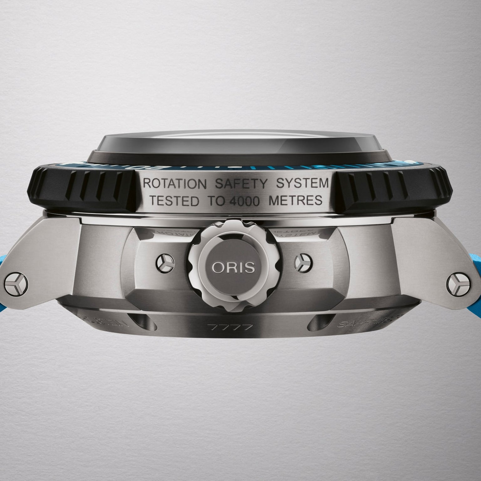 Side view of the Oris Aquis Pro 4000M showing its metal case, branded crown, ROTATION SAFETY SYSTEM TESTED TO 4000 METRES text, and blue strap. Powered by the Calibre 400 movement.
