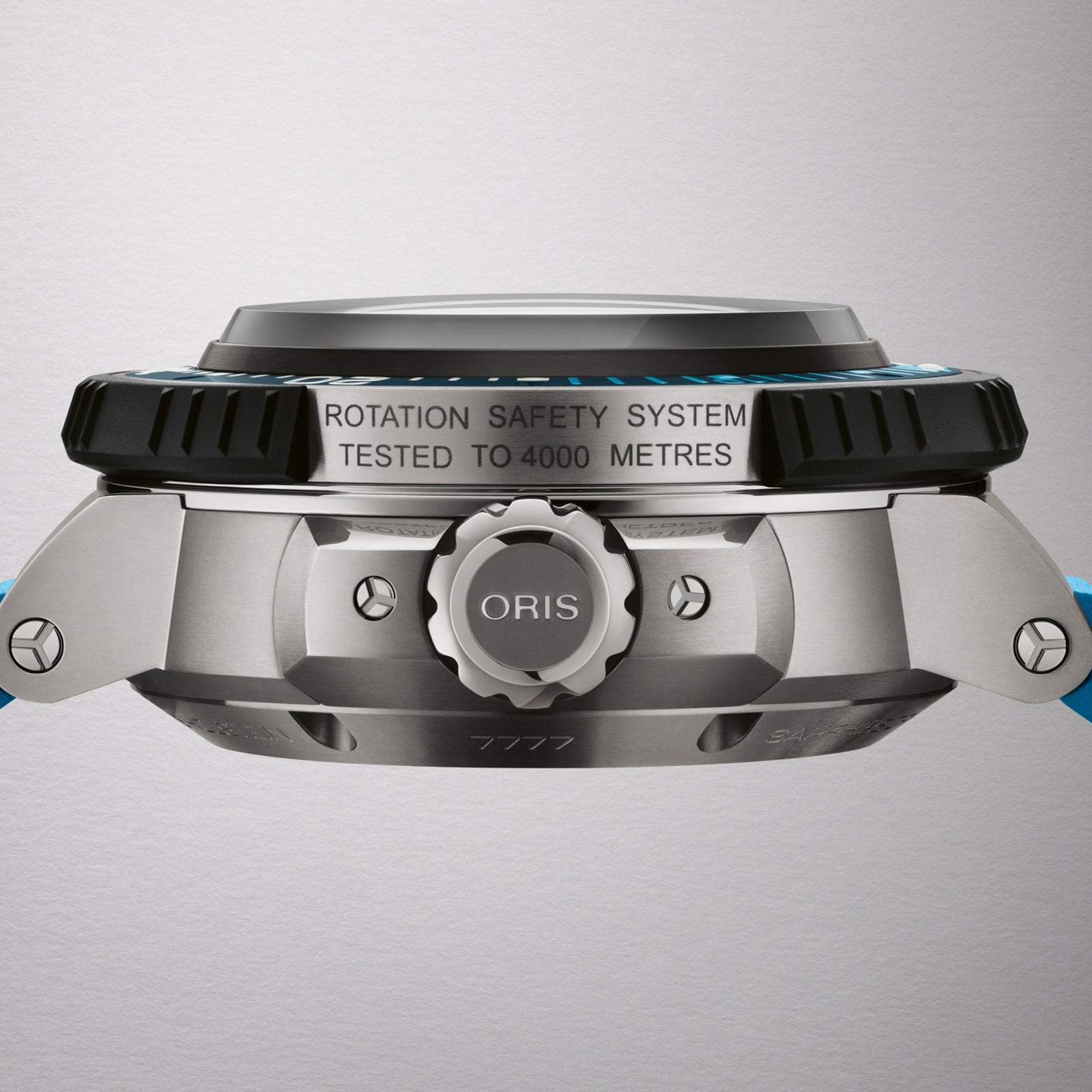 Side view of the Oris Aquis Pro 4000M showing its metal case, branded crown, ROTATION SAFETY SYSTEM TESTED TO 4000 METRES text, and blue strap. Powered by the Calibre 400 movement.