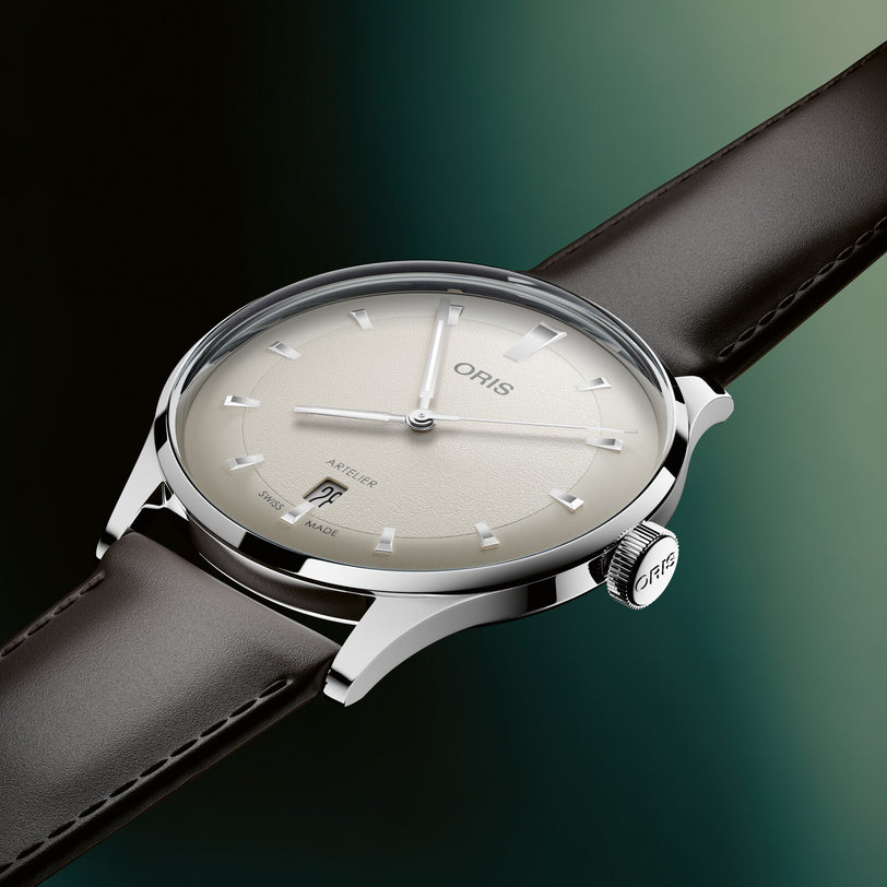 Oris watch with a black leather strap on a gradient green background