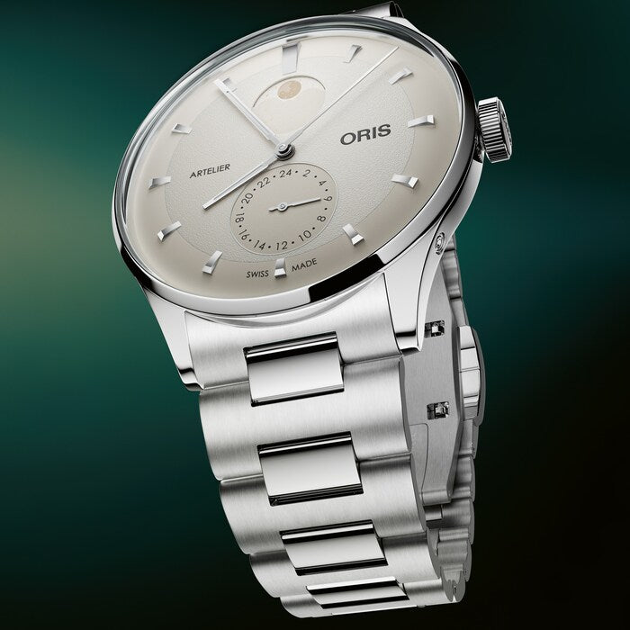 Stainless steel watch with silver dial, moon phase subdial, date window, and matching metal bracelet.