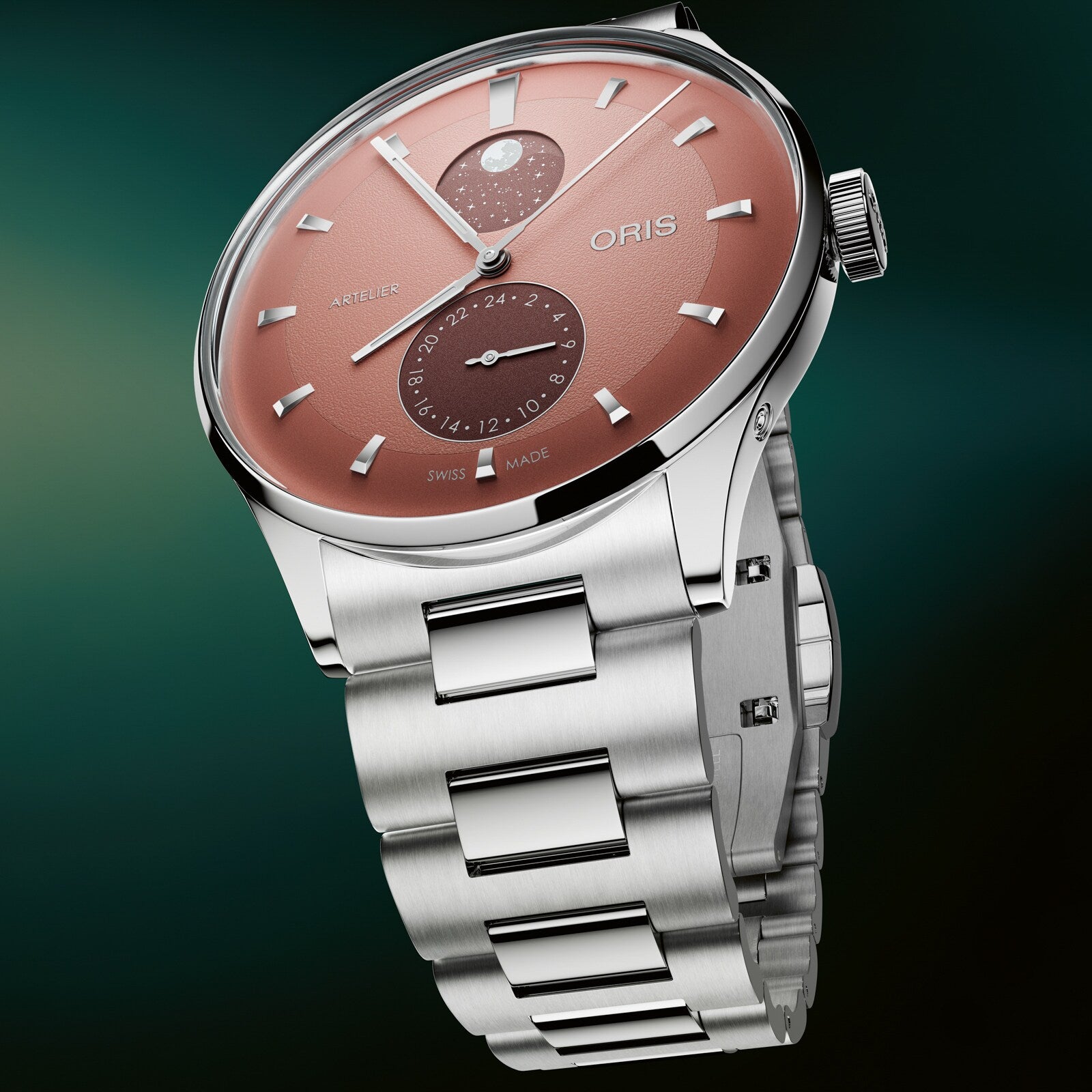 Silver and rose dial watch with moonphase display, secondary dial, and metal bracelet on green background.