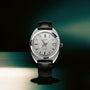 Oris stainless steel automatic watch with silver dial, date window, and black leather strap.