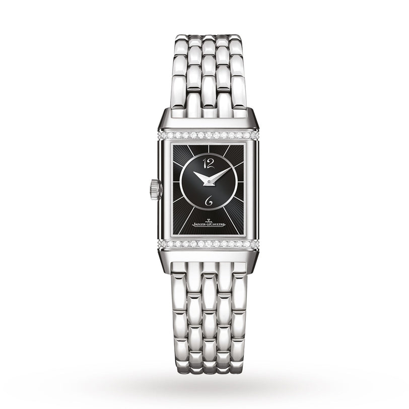 The Jaeger-LeCoultre Reverso Classic is a rectangular ladies’ watch with a black dial, silver hour markers, metal link band, and Arabic numerals at 12 and 6 o’clock. A diamond bezel at the top and bottom adds classic elegance.