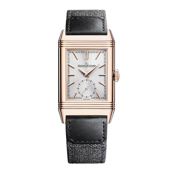 The Jaeger-LeCoultre Reverso Tribute Small Seconds is a rectangular luxury watch with a reversible gold case, silver dial, black leather strap, small seconds subdial at 6 o’clock, gold hour markers, and the Jaeger-LeCoultre logo.