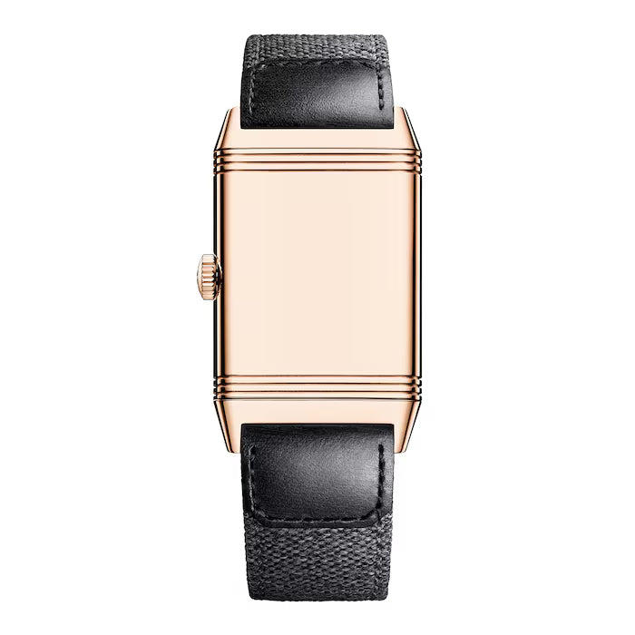 The Jaeger-LeCoultre Reverso Tribute Small Seconds is a rectangular gold Art Deco watch with a plain face, ridged frame, left-side crown, and a black textured leather strap.