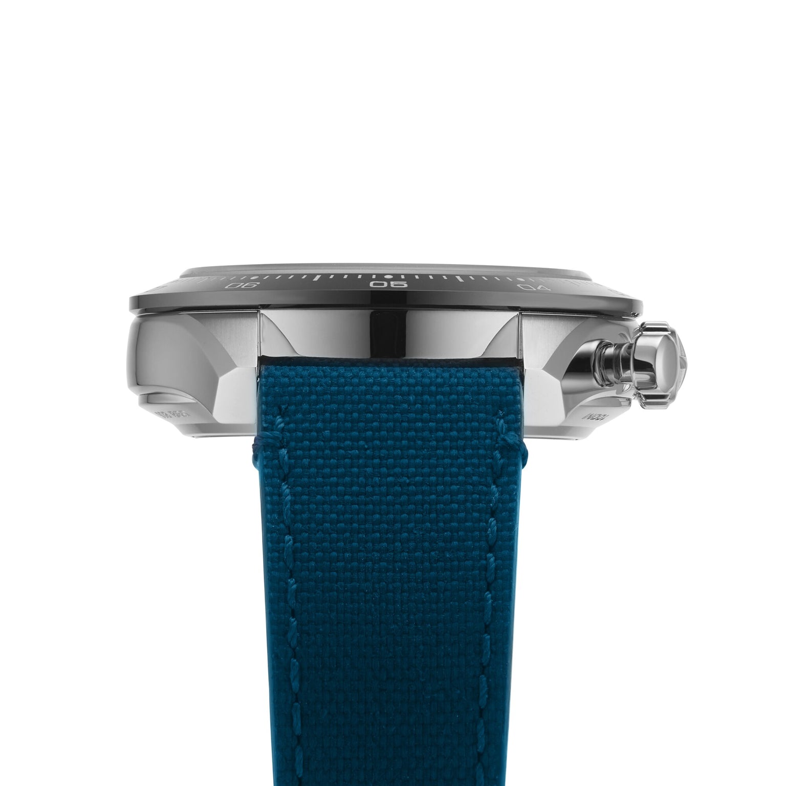 Close-up side view of the Zenith Chronomaster Sport wristwatch featuring a blue textured strap, metallic case, crown, part of the watch face, and refined El Primero movement details.