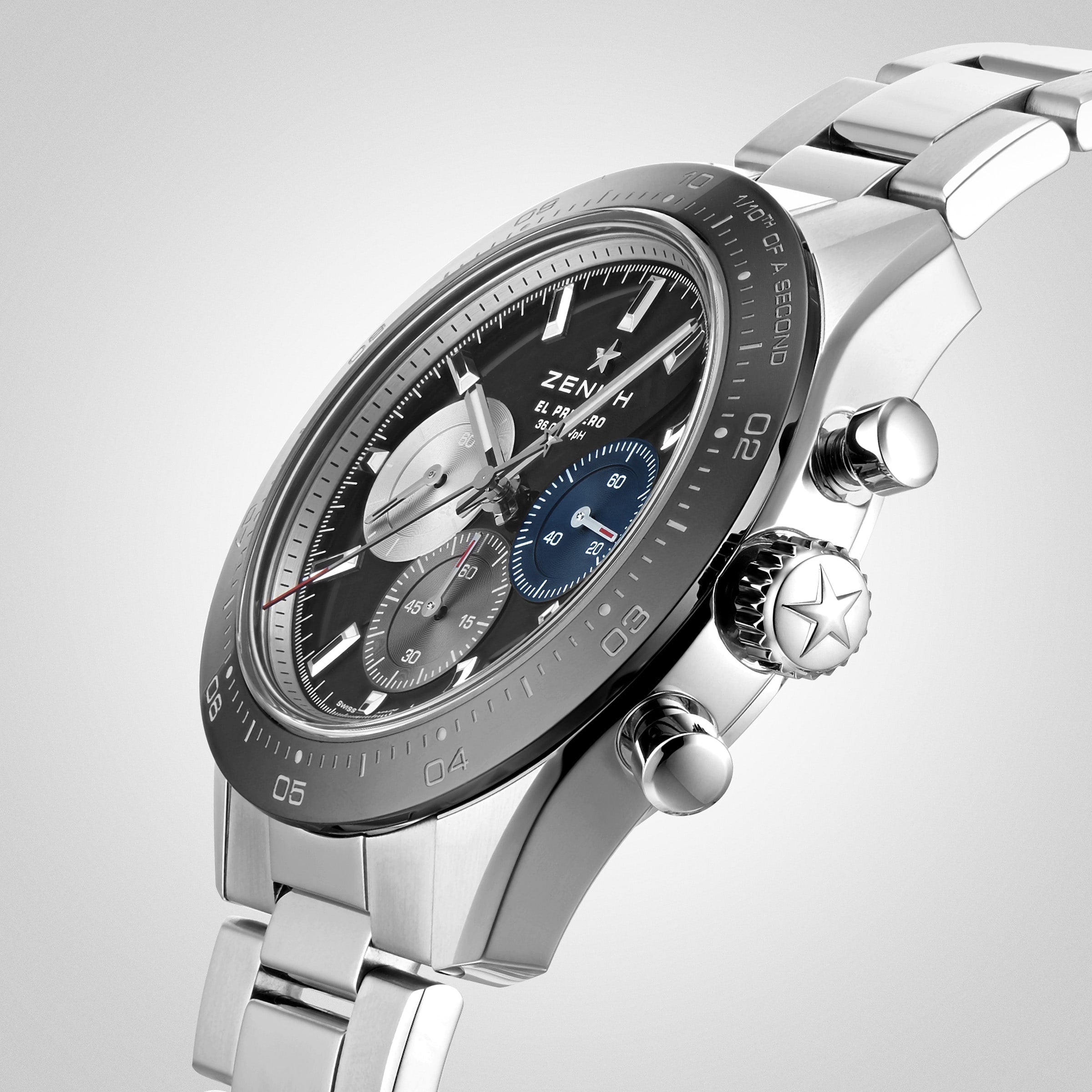 Close-up of a Zenith Chronomaster Sport wristwatch with a black dial, three subdials, and metal bracelet, featuring the El Primero 3600 movement, photographed at an angle on a light background.