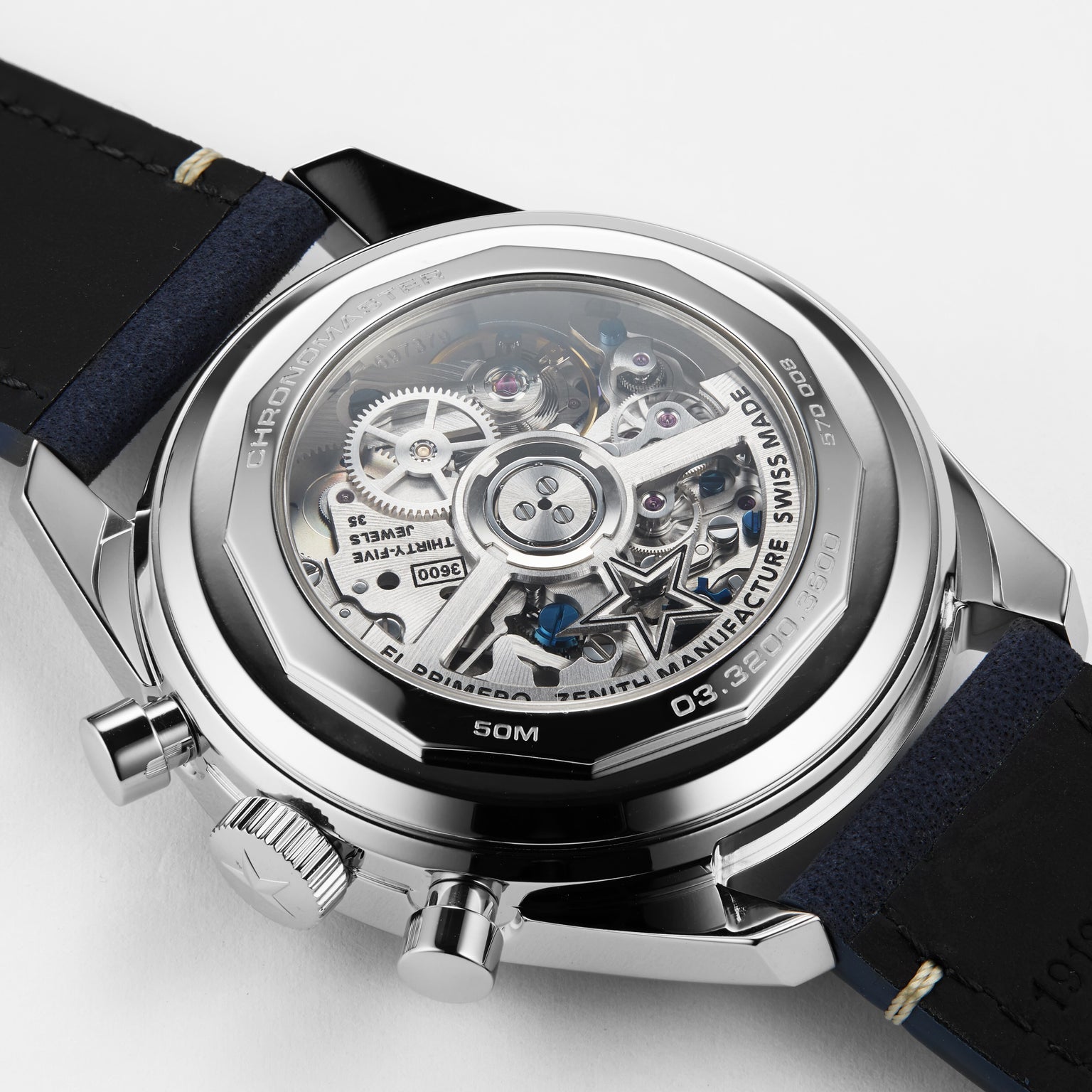 Close-up of the Zenith Chronomaster EP Original’s back, revealing the intricate inner workings and exposed mechanical gears of its El Primero 3600 movement through a transparent case.