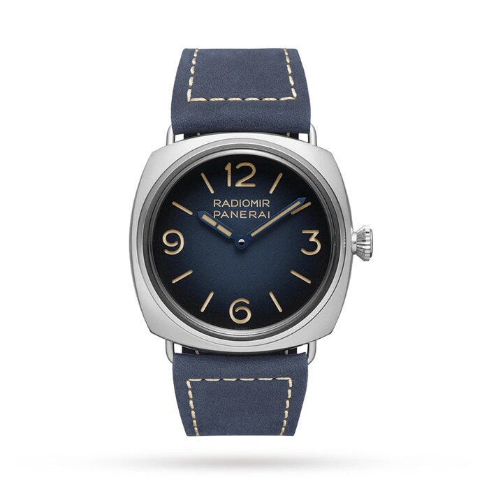 The Panerai Radiomir Origine is a luxury watch featuring a square stainless steel case, blue leather strap, dark blue dial with gold Arabic numerals, and distinctive Radiomir Panerai branding.