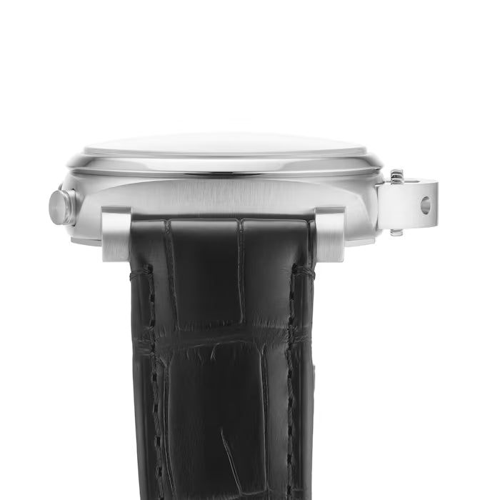 Side view of the Panerai Luminor Chrono wristwatch with a round silver case and black leather strap, highlighting its crown and lugs, set against a white background.