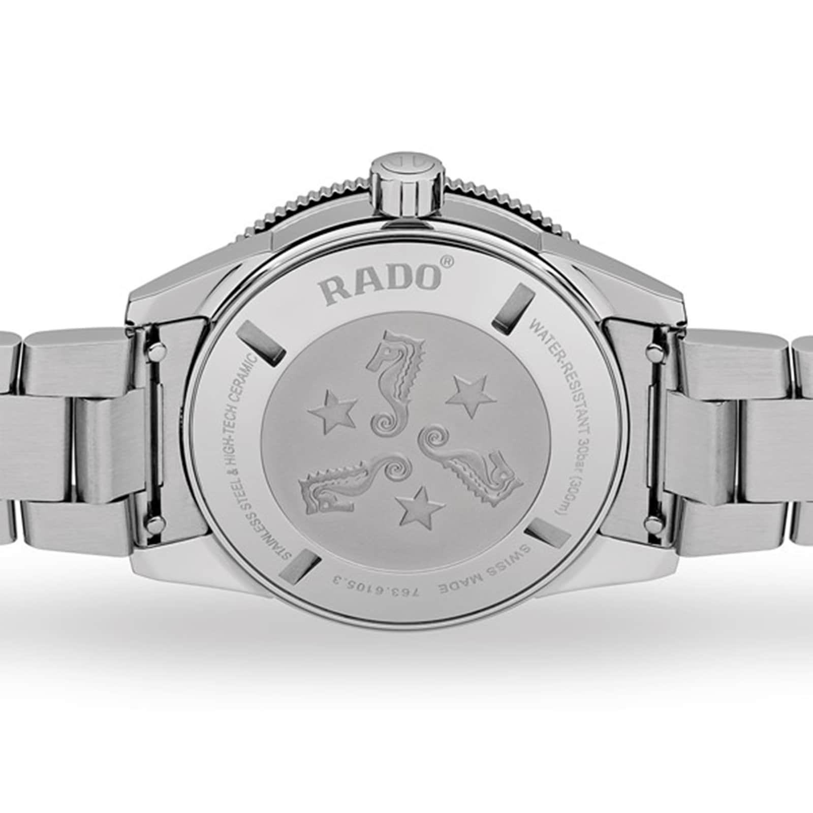 The back of the Rado Captain Cook Automatic watch showcases engraved seahorses, stars, and text highlighting its water resistance and Swiss-made vintage design.