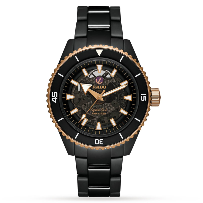 A Rado Captain Cook High-Tech Ceramic wristwatch with a black and gold skeleton dial, Nivachron™ hairspring, ceramic bezel, stainless steel bracelet, and displaying the time 10:10.