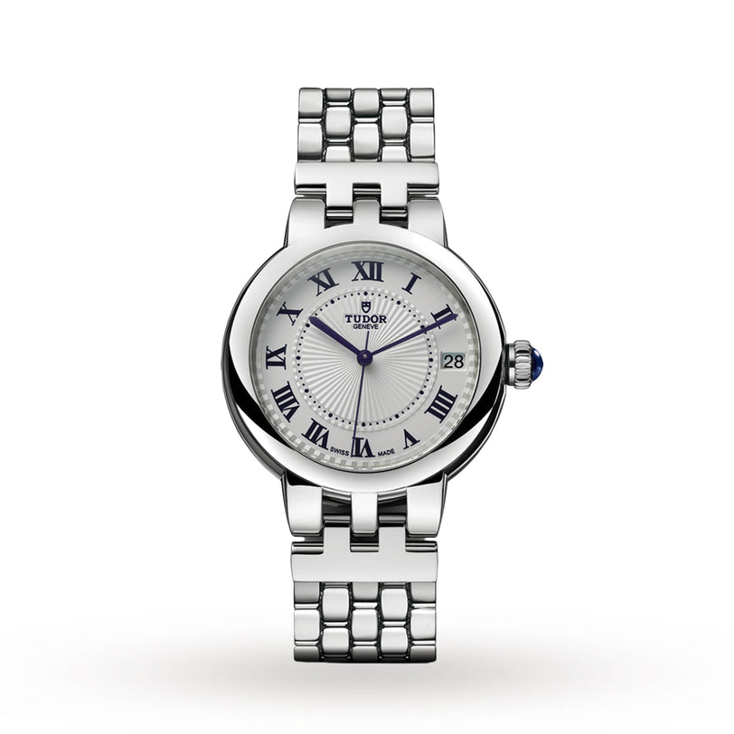 A TUDOR Clair de Rose wristwatch featuring a silver case, white dial, blue Roman numerals, and a metal link bracelet.
