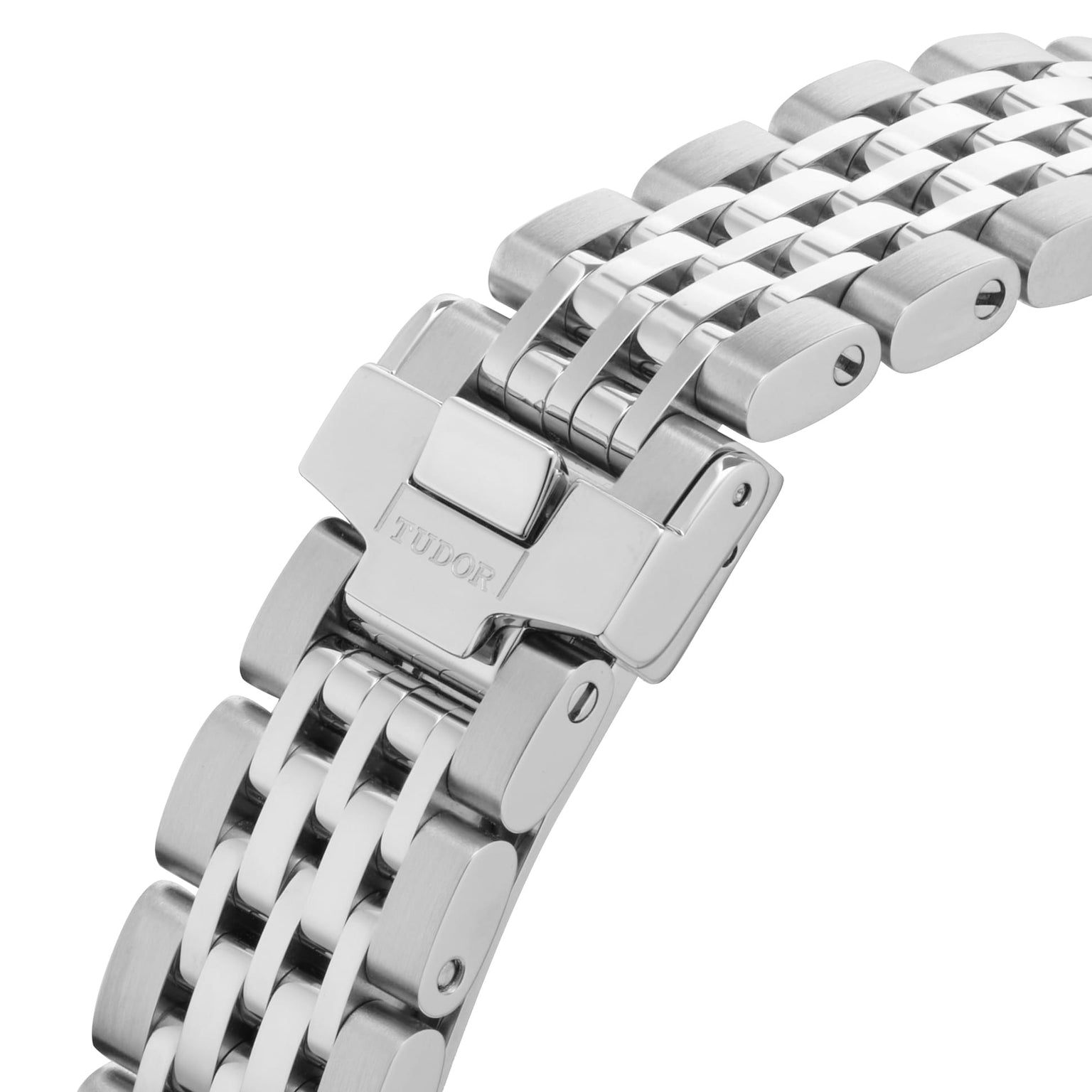 Close-up of the TUDOR 1926 stainless steel bracelet, featuring its clasp and interlocking links, reflects the timeless elegance of this mechanical self-winding watch.