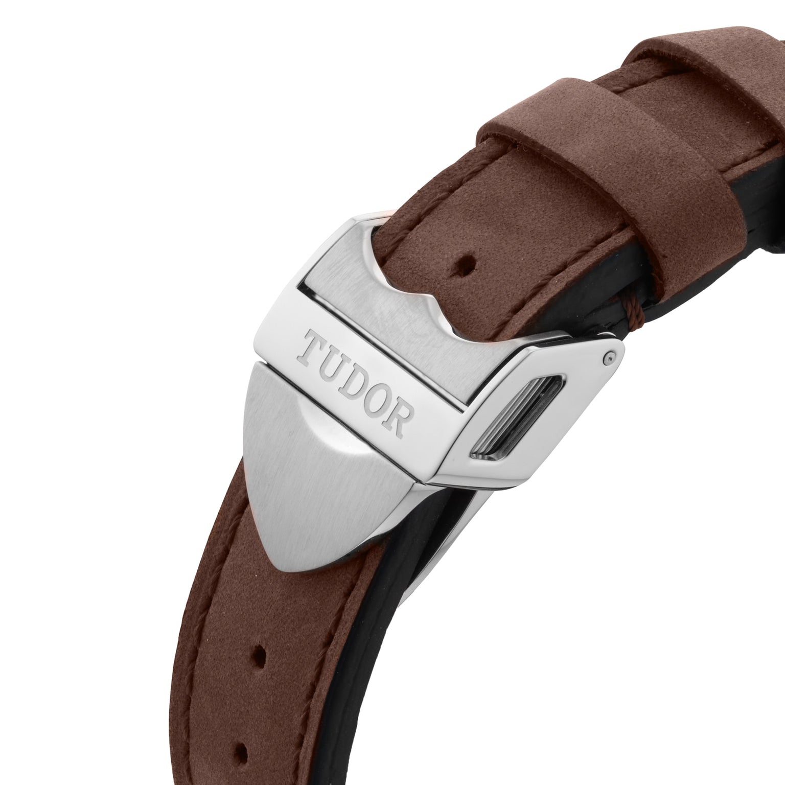 Close-up of a TUDOR Black Bay 58 clasp on a brown leather strap, featuring the engraved brand name on the metal hardware and highlighting its vintage-inspired design.