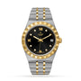 The TUDOR Royal is a two-tone automatic watch featuring a black dial, gold Roman numerals, diamond hour markers, date at 3 o’clock, and a stainless steel and gold bracelet—offering sport-chic style with advanced technical performance.