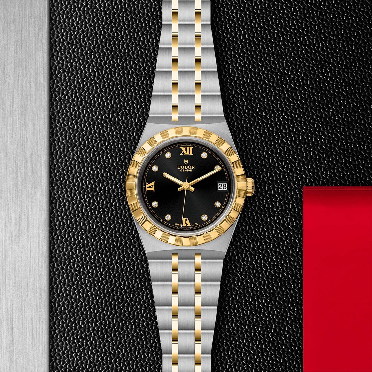 The TUDOR Royal features a black dial with gold Roman numerals and a date display at 3 o’clock, highlighted against a textured black and metallic background—embodying the sport-chic style and technical excellence of TUDOR.