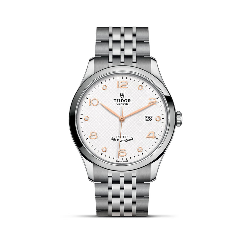 The TUDOR 1926 is a classic stainless steel wristwatch with a white textured dial, gold hour markers, date display at 3 o’clock, and a silver link bracelet—a timeless example of refined watchmaking.