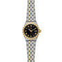 The TUDOR Royal features a black dial, gold Roman numerals, a stainless steel and gold two-tone bracelet, and a date display at 3 o’clock—an elegant automatic watch from TUDOR’s sport-chic collection.