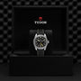 A TUDOR Black Bay Pro wristwatch with a black strap is displayed in a black TUDOR-branded box.
