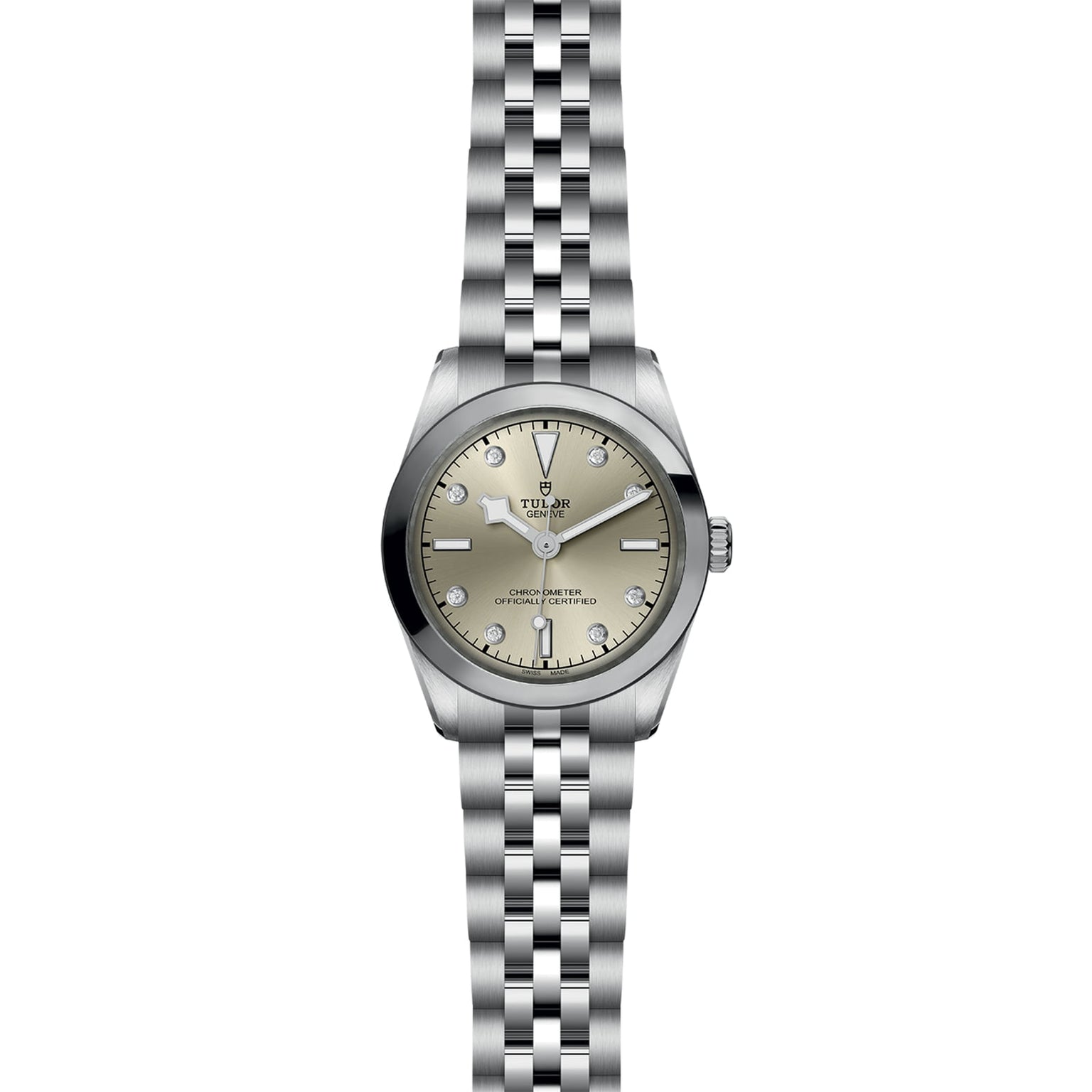 The TUDOR Black Bay One 31 wristwatch features a metal link band, light champagne dial, silver hour markers, and a date window at 3 o’clock; this unisex watch showcases refined watchmaking and is pictured from above on a white background.