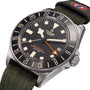 A TUDOR Pelagos FXD GMT watch featuring a black dial, rotatable bezel, and green fabric strap.