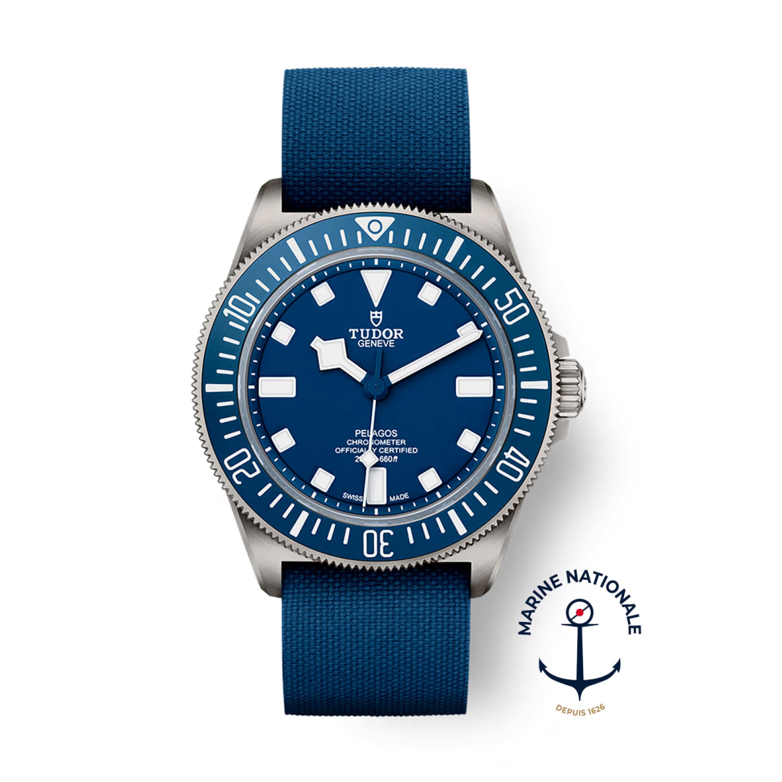 The TUDOR Pelagos FXD dive watch features a blue dial and bezel, blue fabric strap, titanium case, and the Marine Nationale logo in the lower right corner.