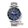 The TUDOR Black Bay 68 is a dive watch featuring a blue dial, steel bracelet, and black bezel with the TUDOR logo below.