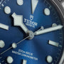 Close-up of a TUDOR Black Bay 68 watch face in blue, featuring bold hands and markers, with 200m:660ft indicated.