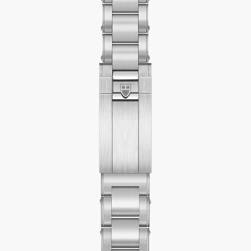 Close-up of the TUDOR Black Bay Chronos stainless steel bracelet clasp, featuring an engraved shield logo.