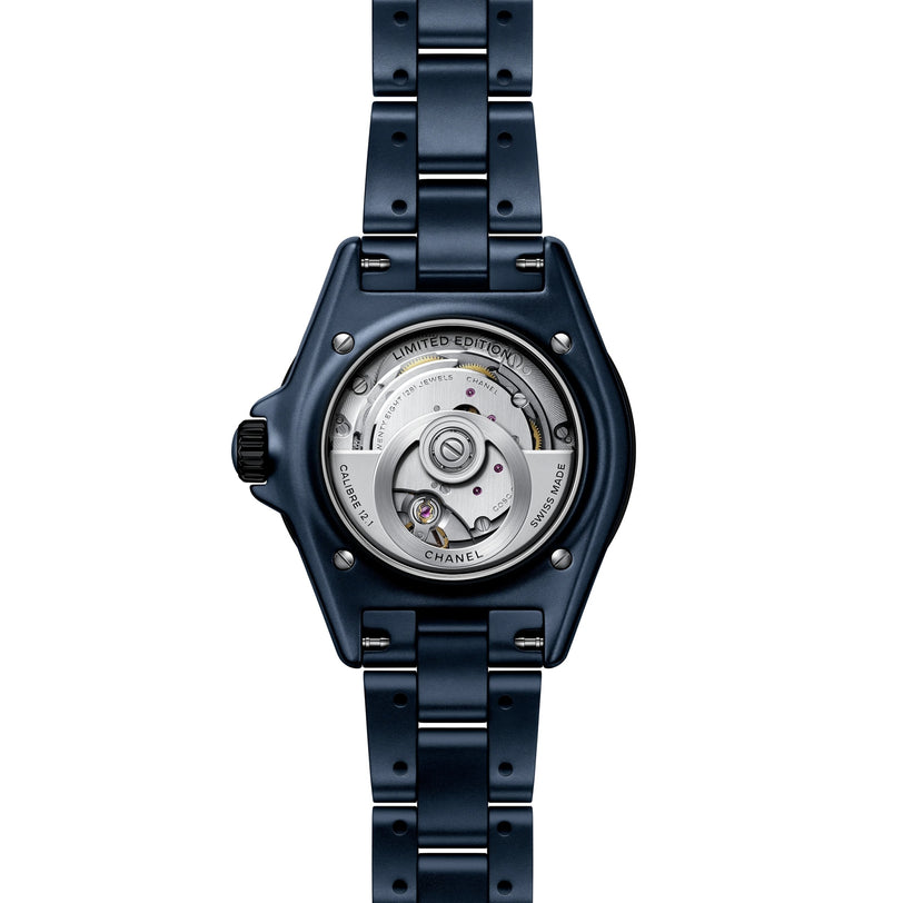 Back view of the Chanel J12 Bleu Watch Caliber 12.1, 38 mm in blue metal, revealing its exposed mechanical movement and Limited Edition engraving.