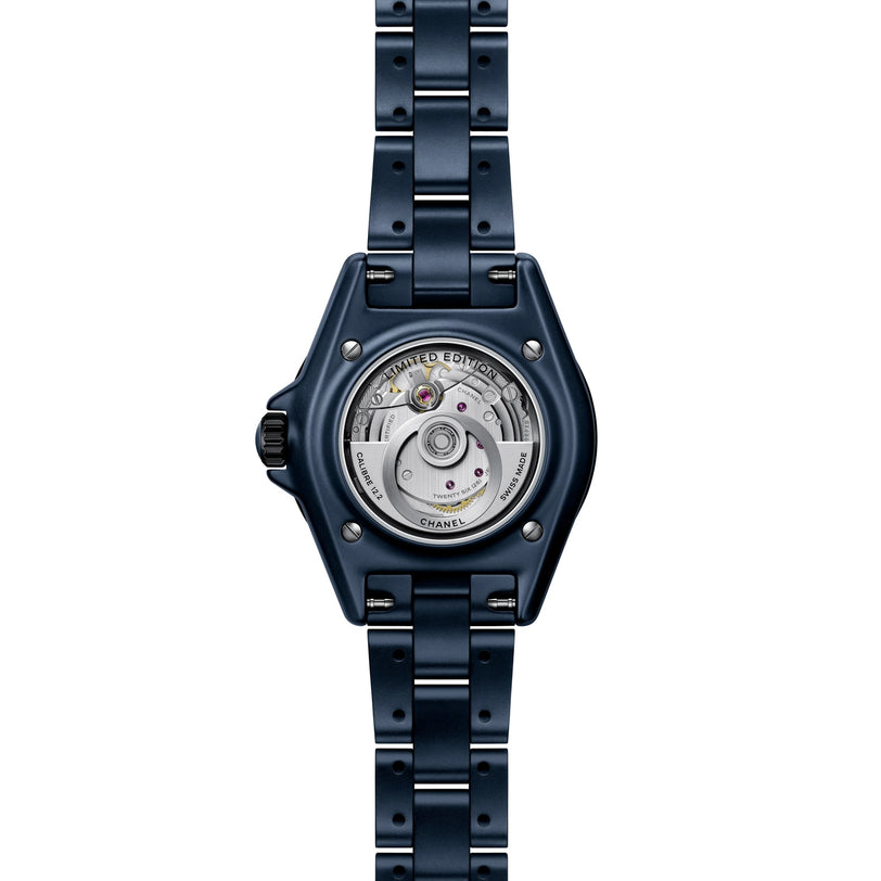The Chanel J12 Bleu Watch Caliber 12.2, 33 mm features a blue design, visible mechanical movement, and limited edition engraving on the back.